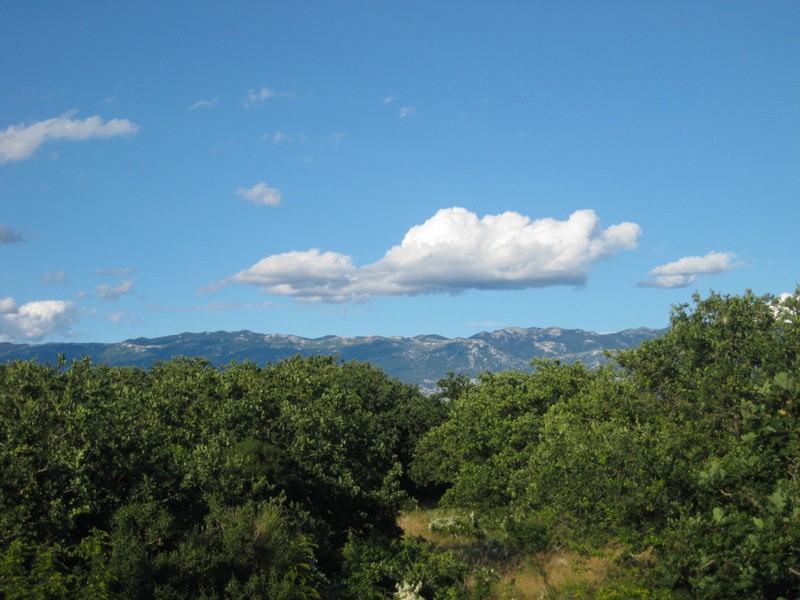 View over the Mediterranean landscape to the mountains of the mainland