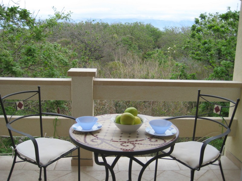 Balcony with table and view of Mediterranean landscape