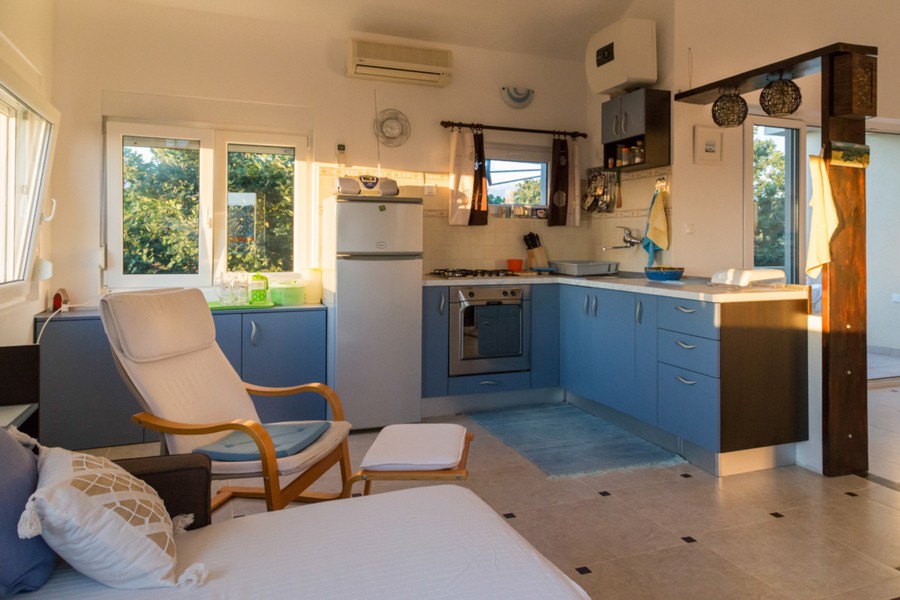 Open plan living area with kitchen and sea views