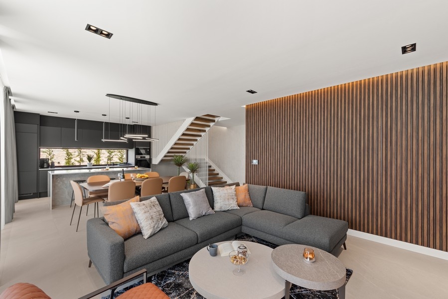 Living room with designer furniture and open kitchen