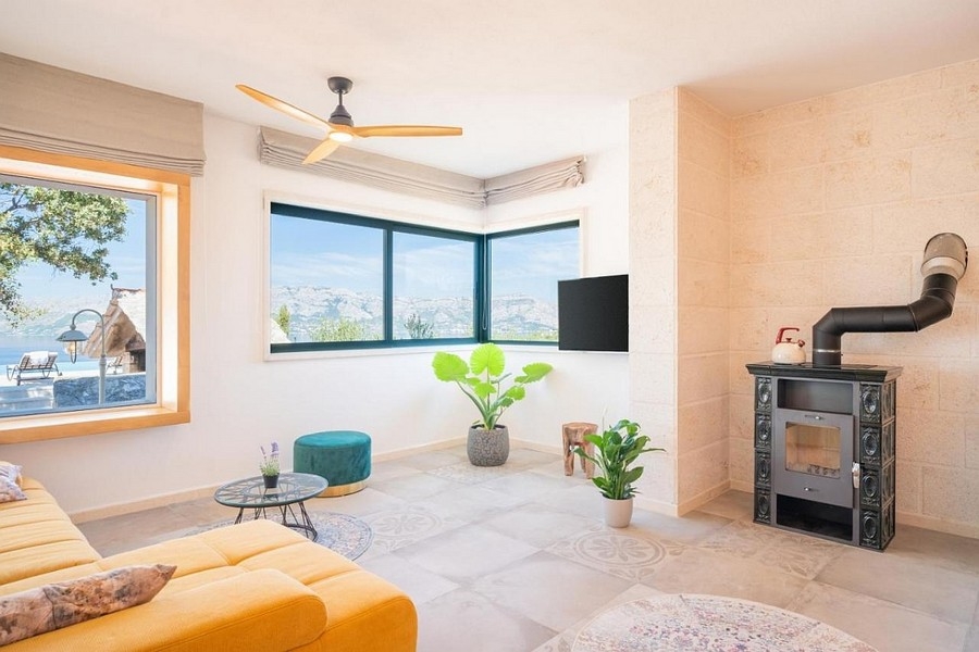 Bright living area with fireplace and panoramic windows