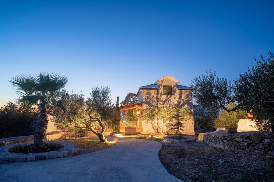 Dalmatian house in the evening atmosphere with illuminated garden