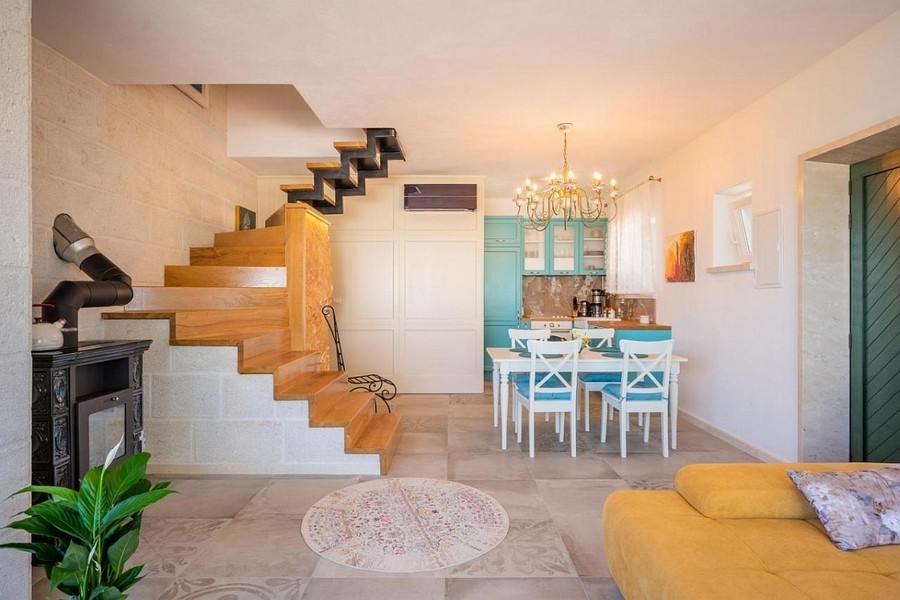 Living area with open kitchen and Dalmatian style staircase