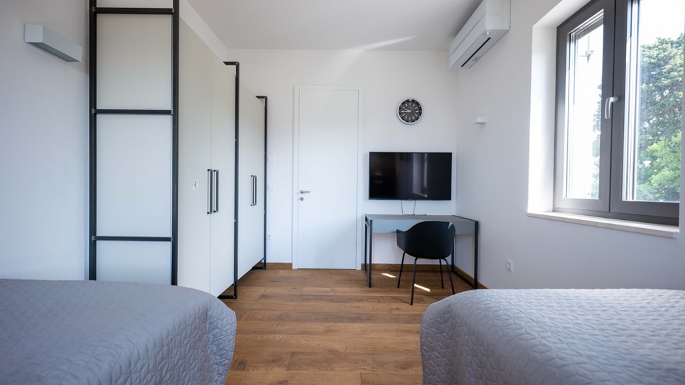 Room with two beds and work area