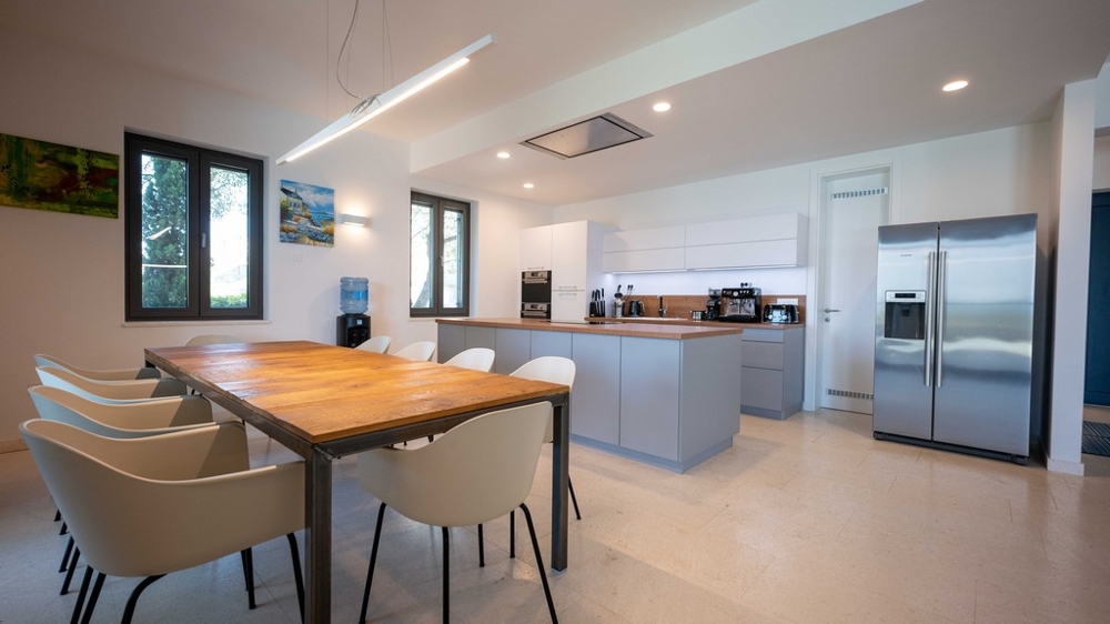 Modern kitchen with cooking island and large dining table