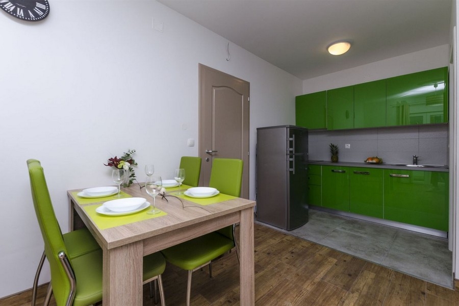 Kitchen with green fitted kitchen and dining area