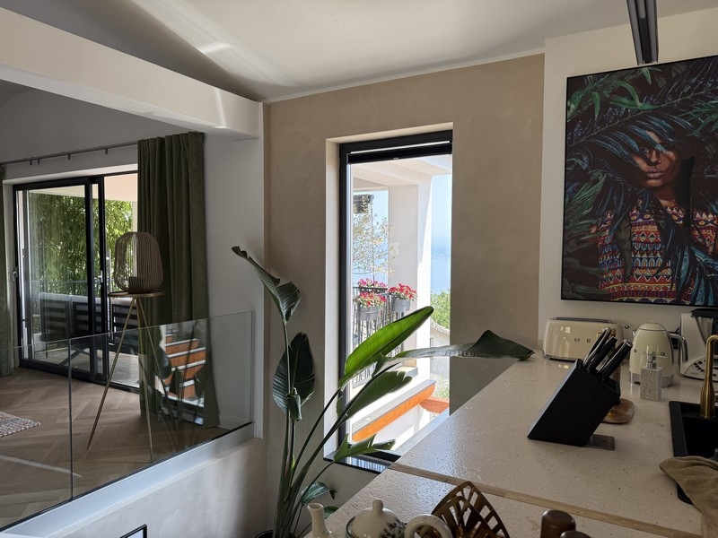 Kitchen with view of balcony and surroundings