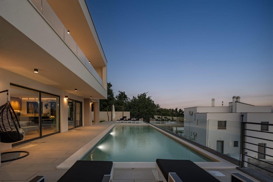 Modern villa with infinity pool and sea views in the evening