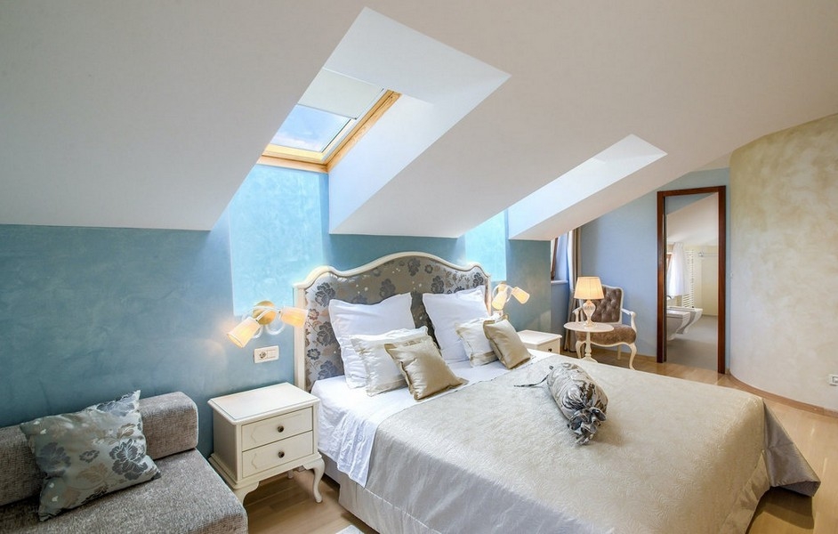 Bedroom with skylights and stylish design