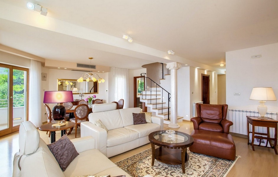 Bright living area with sofa area and staircase