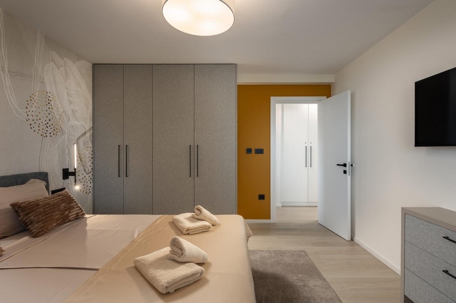 Bright bedroom with built-in wardrobe and modern elements