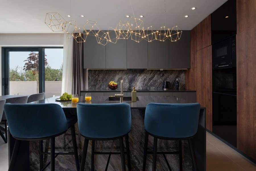 Kitchen with integrated dining area in modern villa