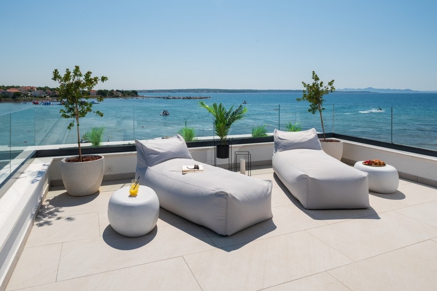 Roof terrace with sunbathing areas and panoramic sea views