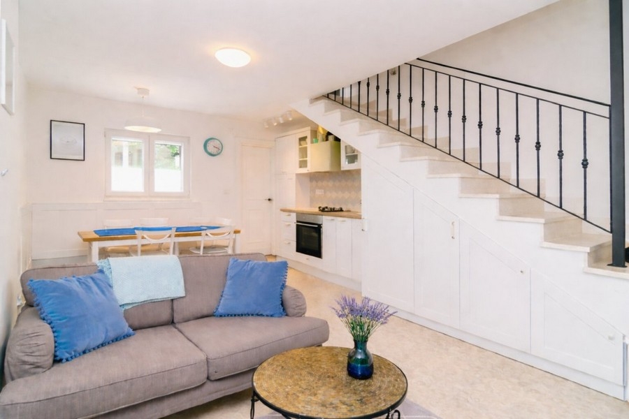 Open living area with kitchen and stairs