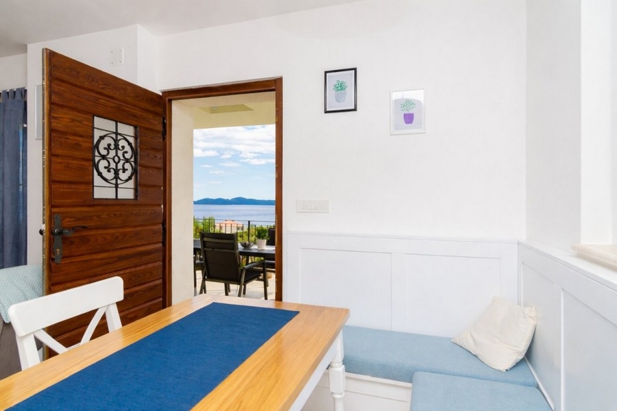 Dining area with access to the terrace and sea views