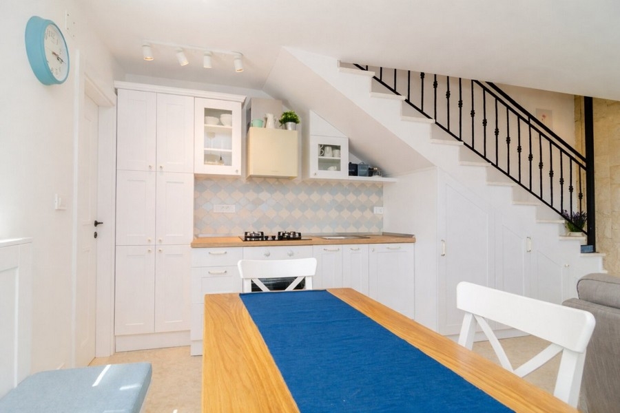 Kitchen with fitted cupboards and work surface