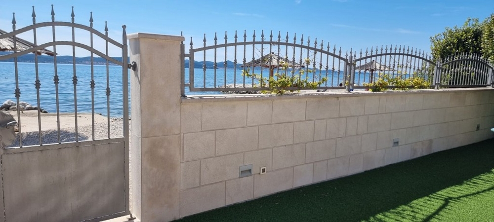 Fenced property with gate and views of the beach and sea in a quiet location