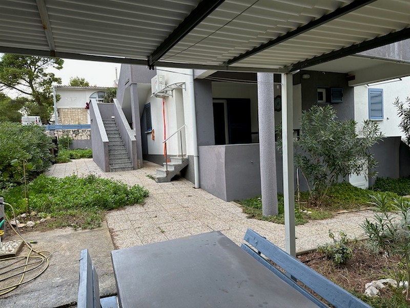 Outdoor area with terrace, pergola and access to the residential units