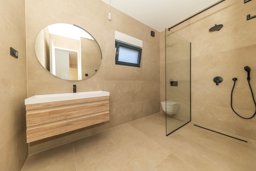 Bathroom with floor-level shower and modern equipment