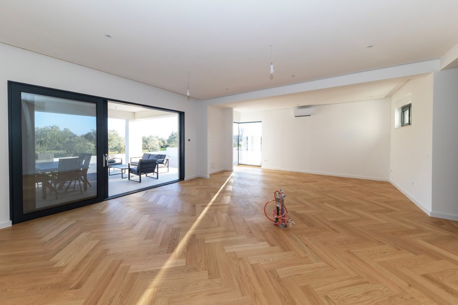 Open living area with large windows and access to the terrace