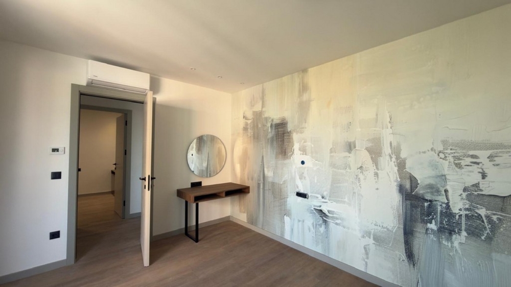 Room with desk and mirror.