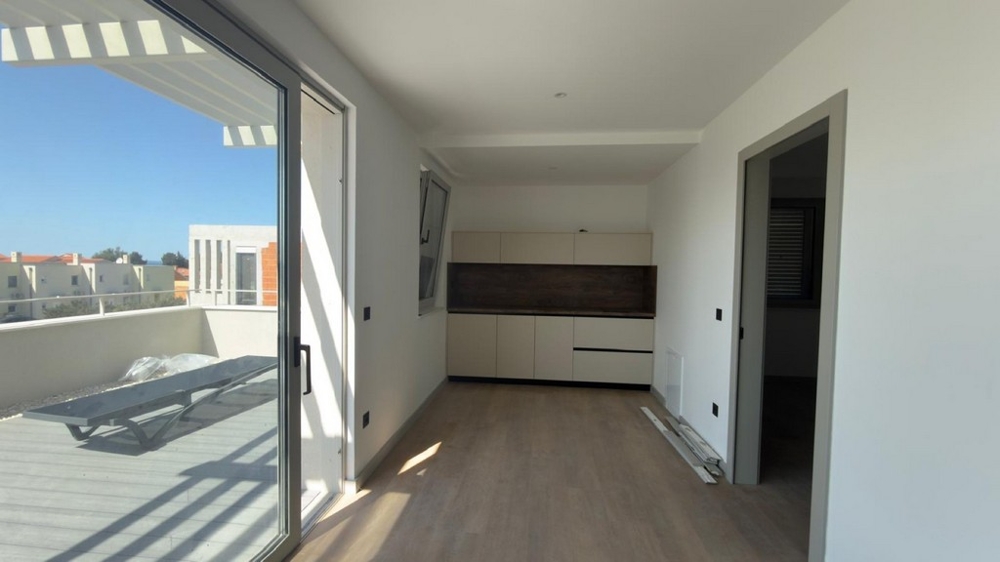 Bright living area with open kitchen and terrace access