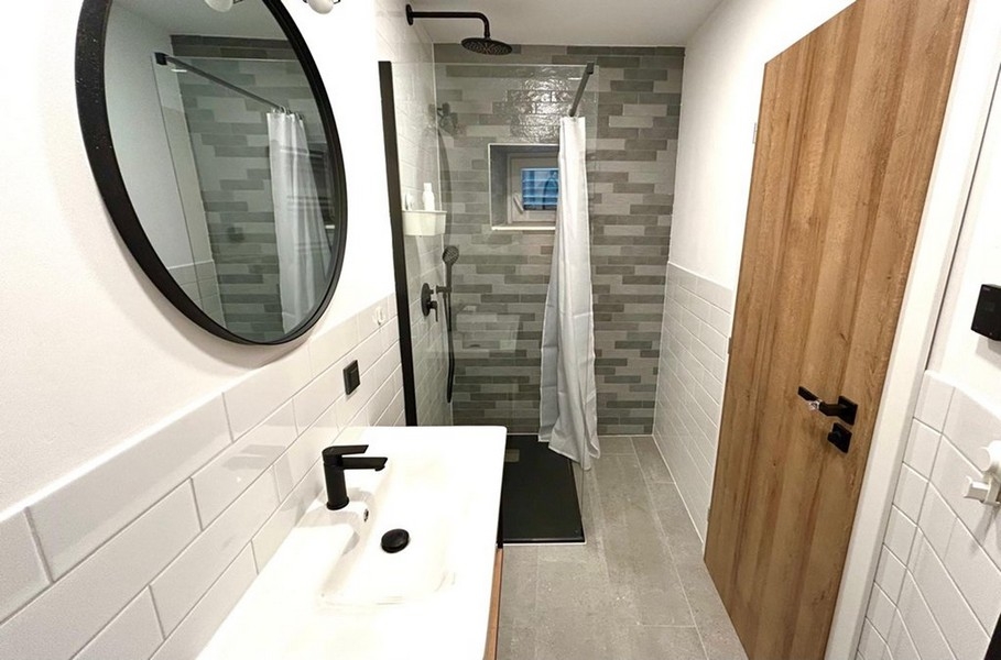 Bathroom with floor-level shower and modern equipment