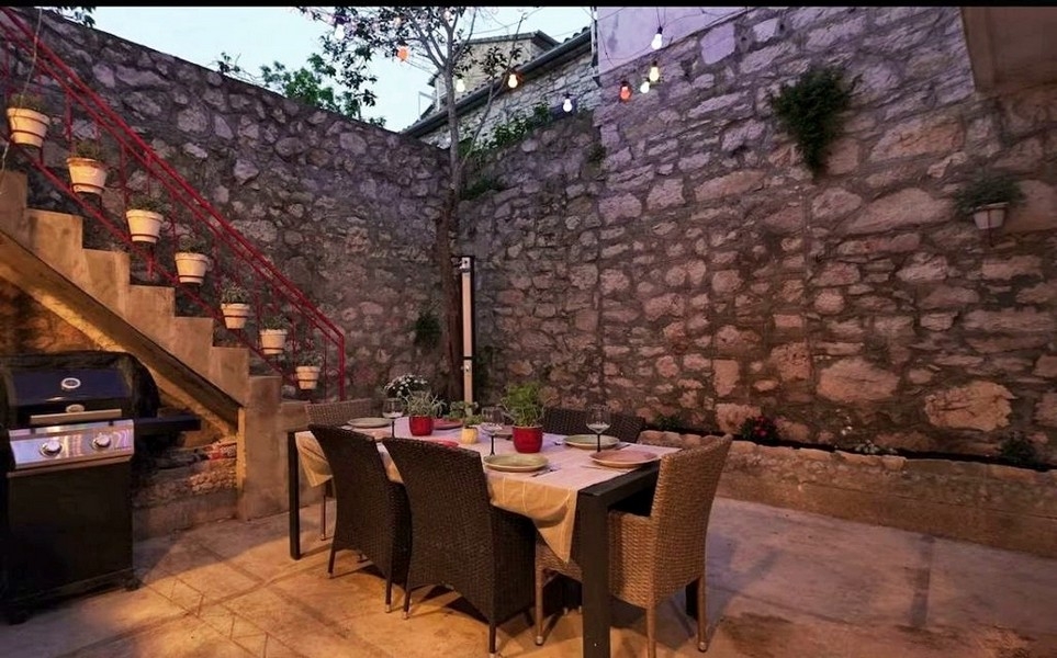 Inner courtyard with natural stone wall and outdoor seating area