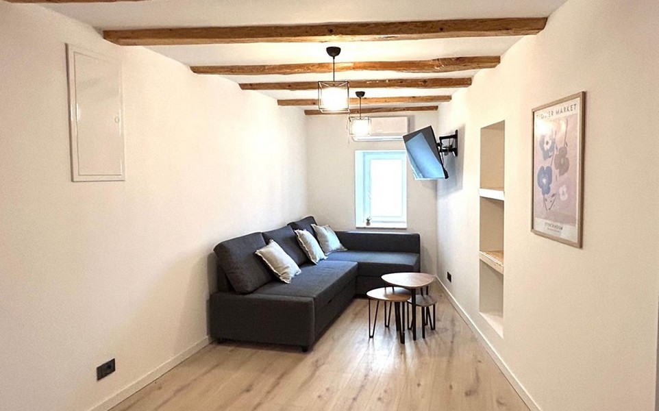 Living area with sofa and beamed ceiling