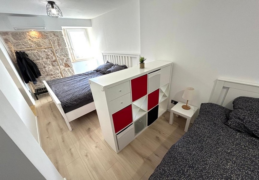 Bedroom with double bed and room divider