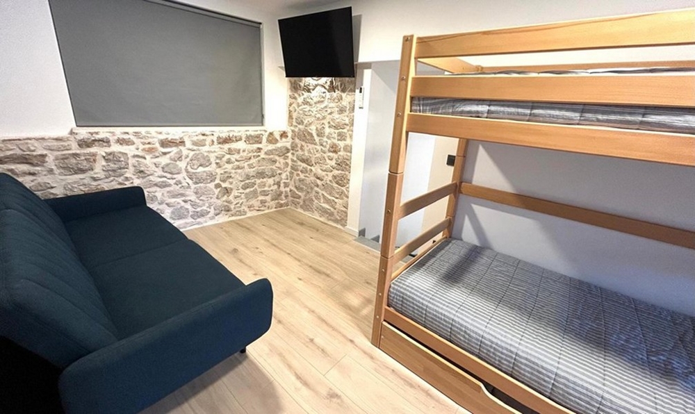 Room with bunk bed and additional sofa bed