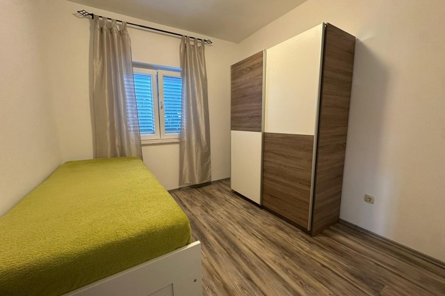 Bedroom with single bed and wardrobe in bright furnishings