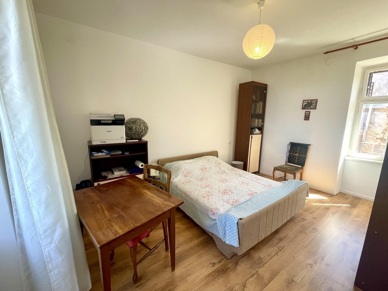 Bedroom with double bed and wooden floor