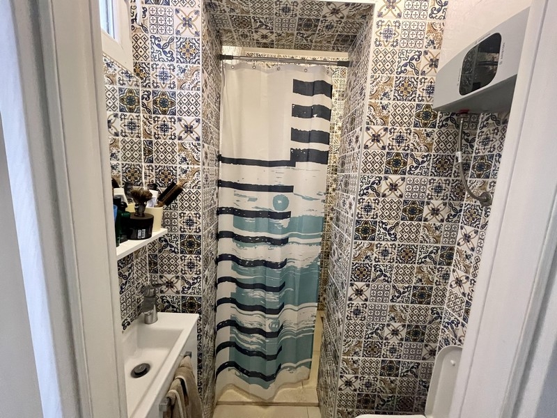 Bathroom with shower and patterned tiles
