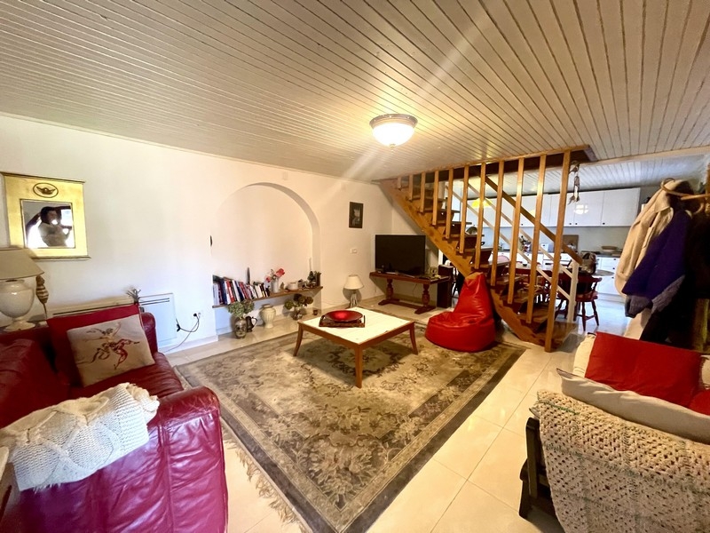 Living room with sofa, carpet and open staircase