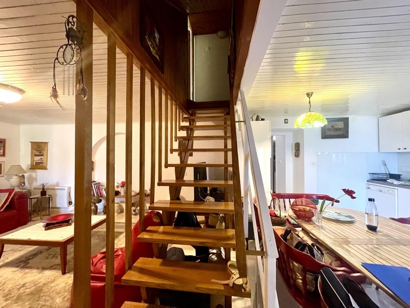 Open living area with stairs and kitchen