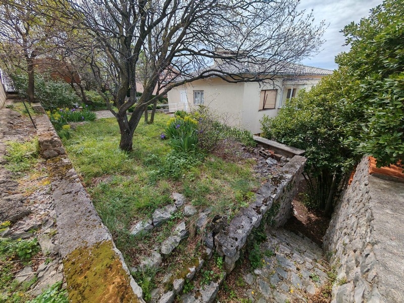 Stairs lead down to the house.