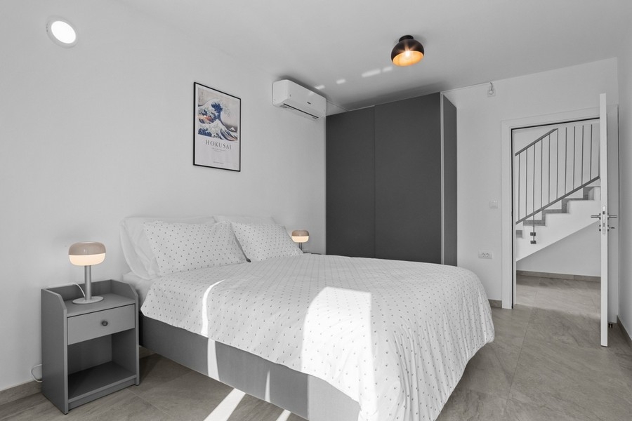 Bright bedroom with air conditioning and built-in wardrobe