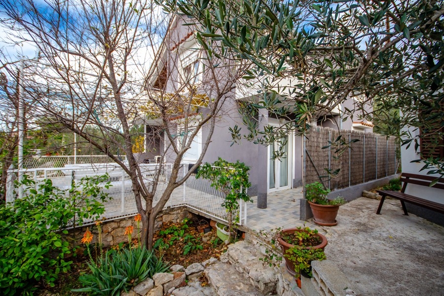 Spacious terrace with seating area and pergola outside