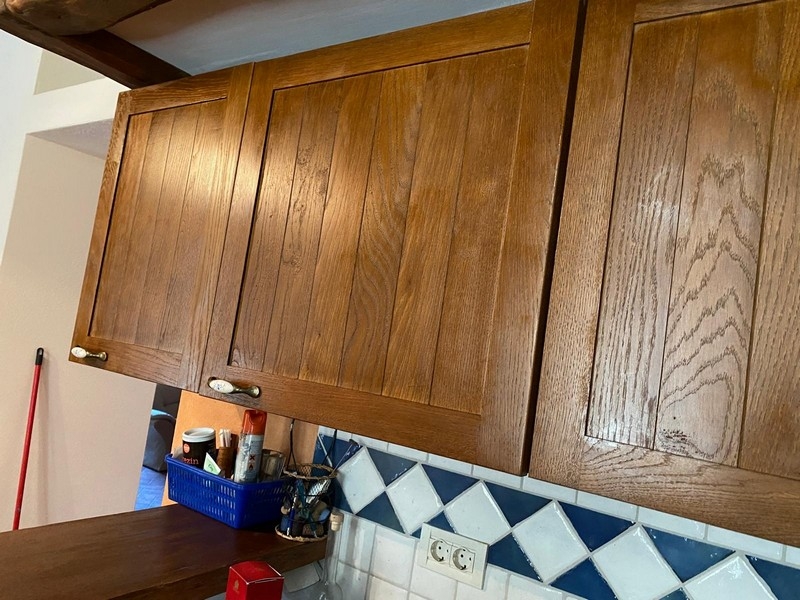 Detailed view of the wooden kitchen upper cabinets