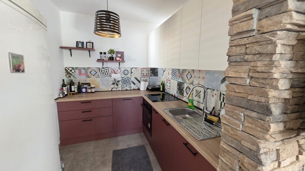 Kitchen with modern fitted kitchen and tile backsplash