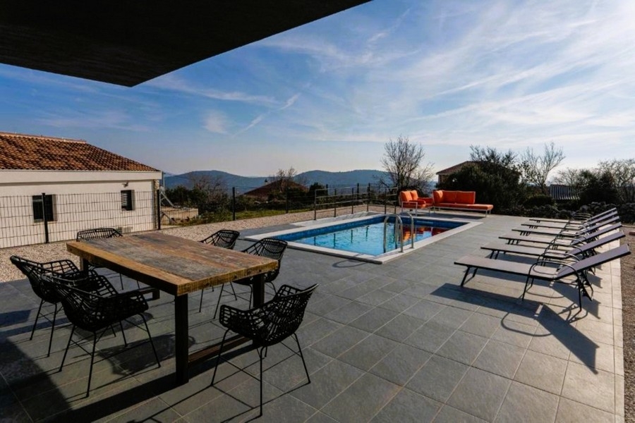 Terrace with swimming pool and mountain views.