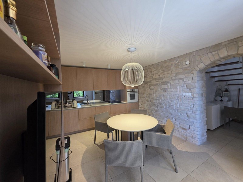 Open kitchen with built-in appliances and dining area