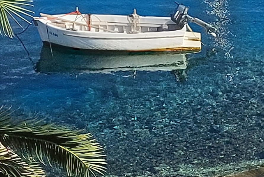 Clear water with boat near shore