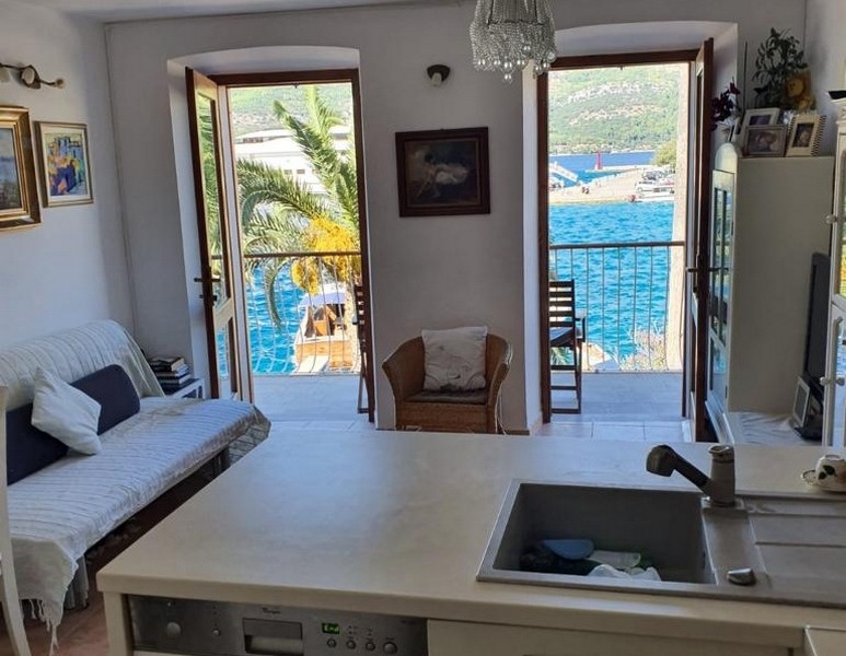 Living area with balcony access and sea views