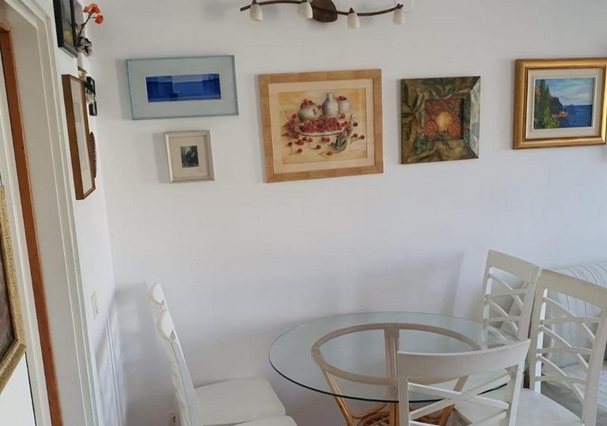 Dining area with round table and wall decoration