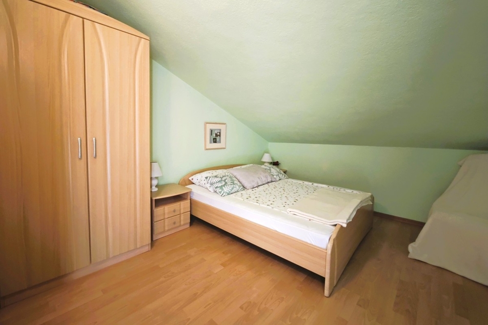 Attic room with sloping ceiling and single bed