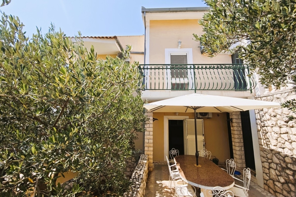 Covered terrace with seating area and olive trees
