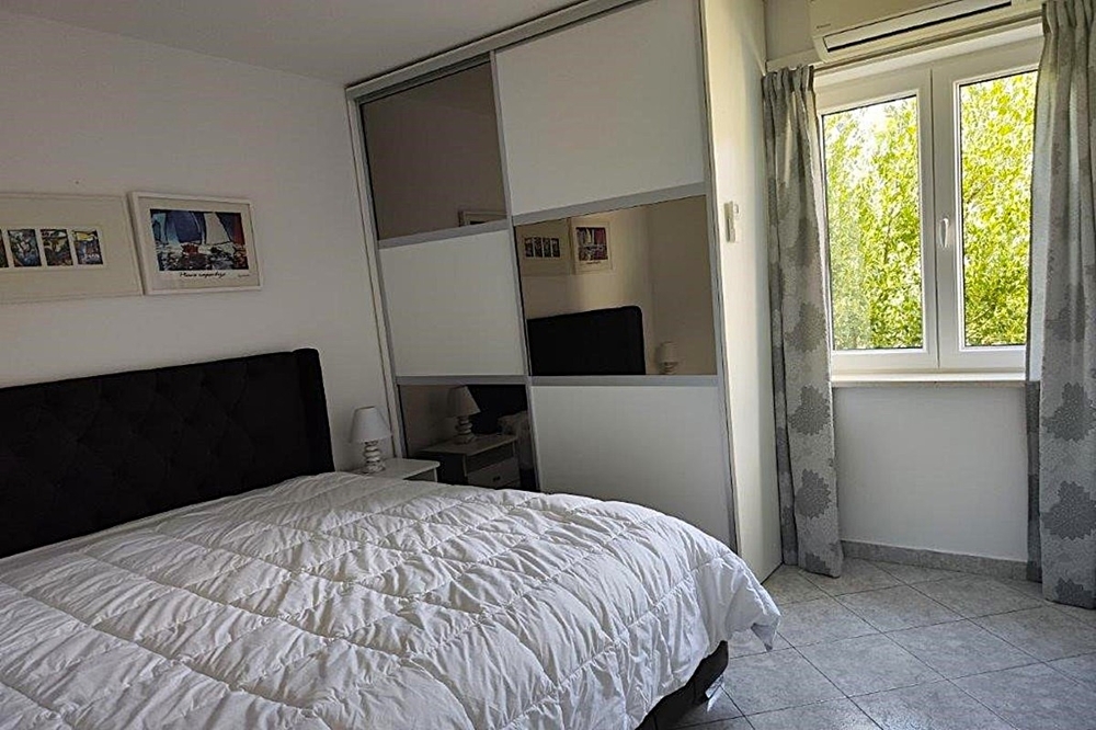 Bedroom with built-in wardrobe and natural light