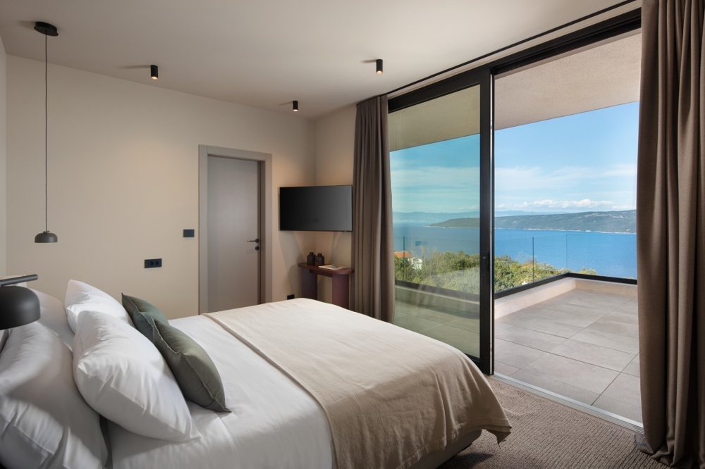 Bedroom with balcony and panoramic sea views